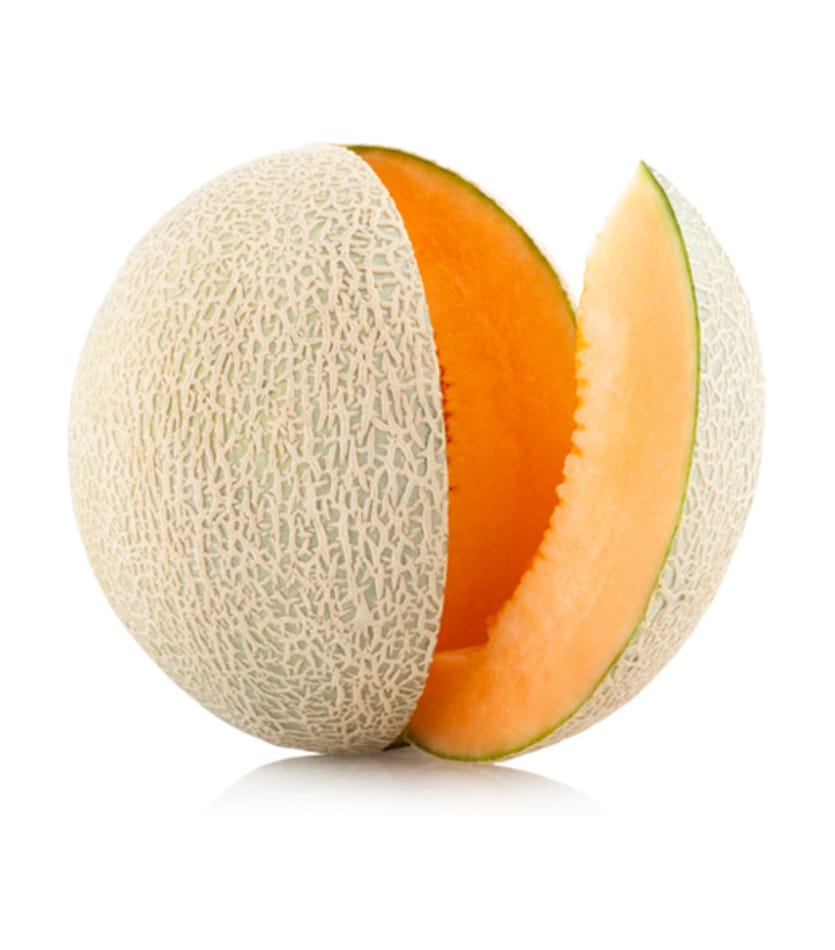 A piece of Cantaloupe is cut in half on a white background.