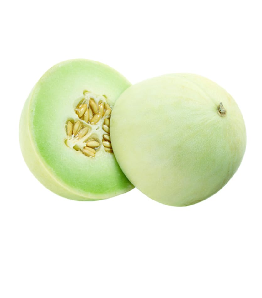 A honey dew is cut in half on a white background.