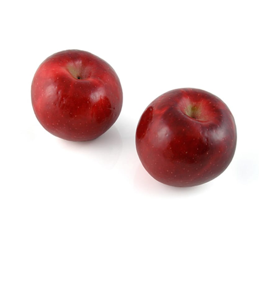 Two rome beauty apples on a white background.